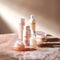 glowoasis ultimate oasis full skincare set on a tabletop, featuring facial cleansers, enzyme exfoliant, balancing toner, hydrating serum, and hydrating gel moisturizer.