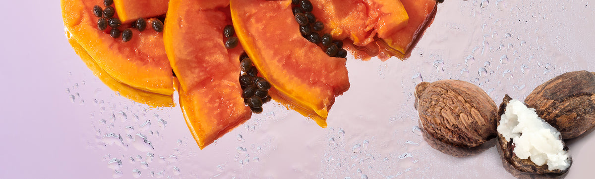 image of papaya and murumuru butter ingredients on a wet, reflective background