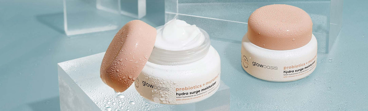one closed bottle of probiotics + murumuru hydra surge moisturizer and one open bottle of probiotics + murumuru hydra surge moisturizer showcasing texture 
