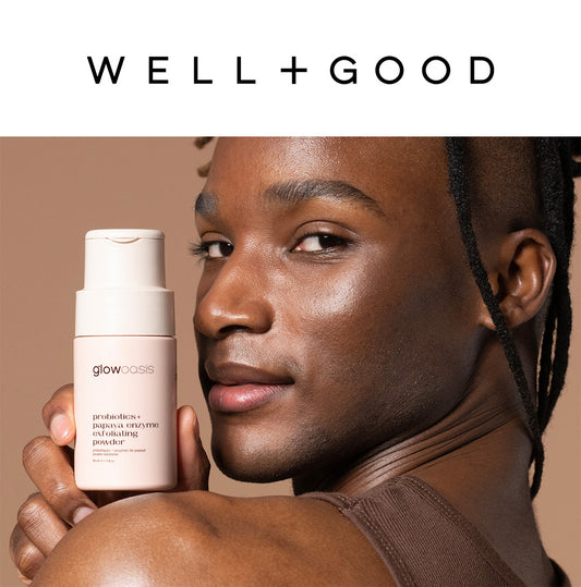 glowoasis probiotics + papaya enzyme exfoliating powder being held by male with glowing skin. WELL+GOOD logo.