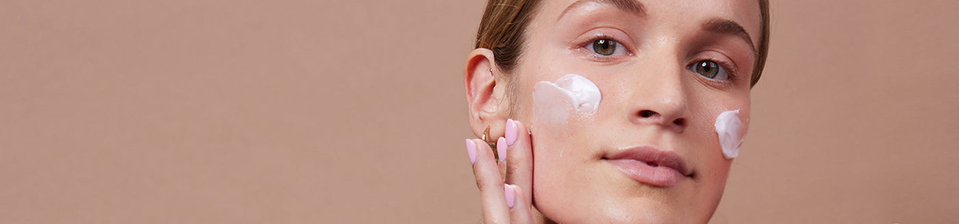 Female model with combination skin that applied probiotics murumuru hydra surge moisturizer cream to both cheeks.