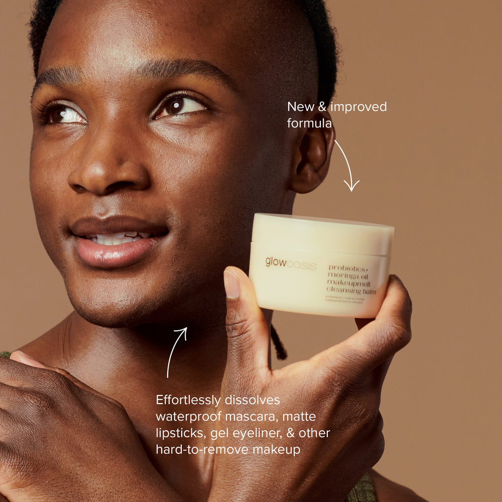Male holding up glowoasis vegan probiotic + moringa oil makeupmelt cleansing balm by his chin for effective makeup removal.