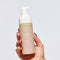 Hand holding glowoasis vegan probiotics cloudcleanse cloud whipped gentle daily foam cleanser