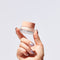 Hand holding glowoasis vegan probiotics anti aging triple peptide refreshing eye cream.